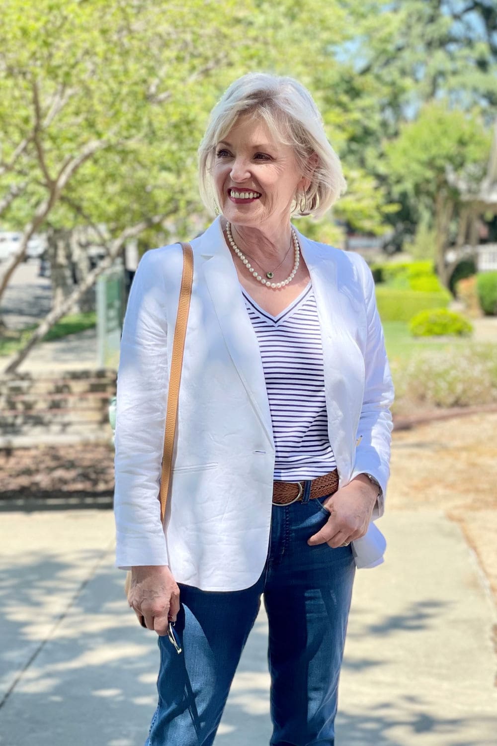 woman smiling in front of greenery at park