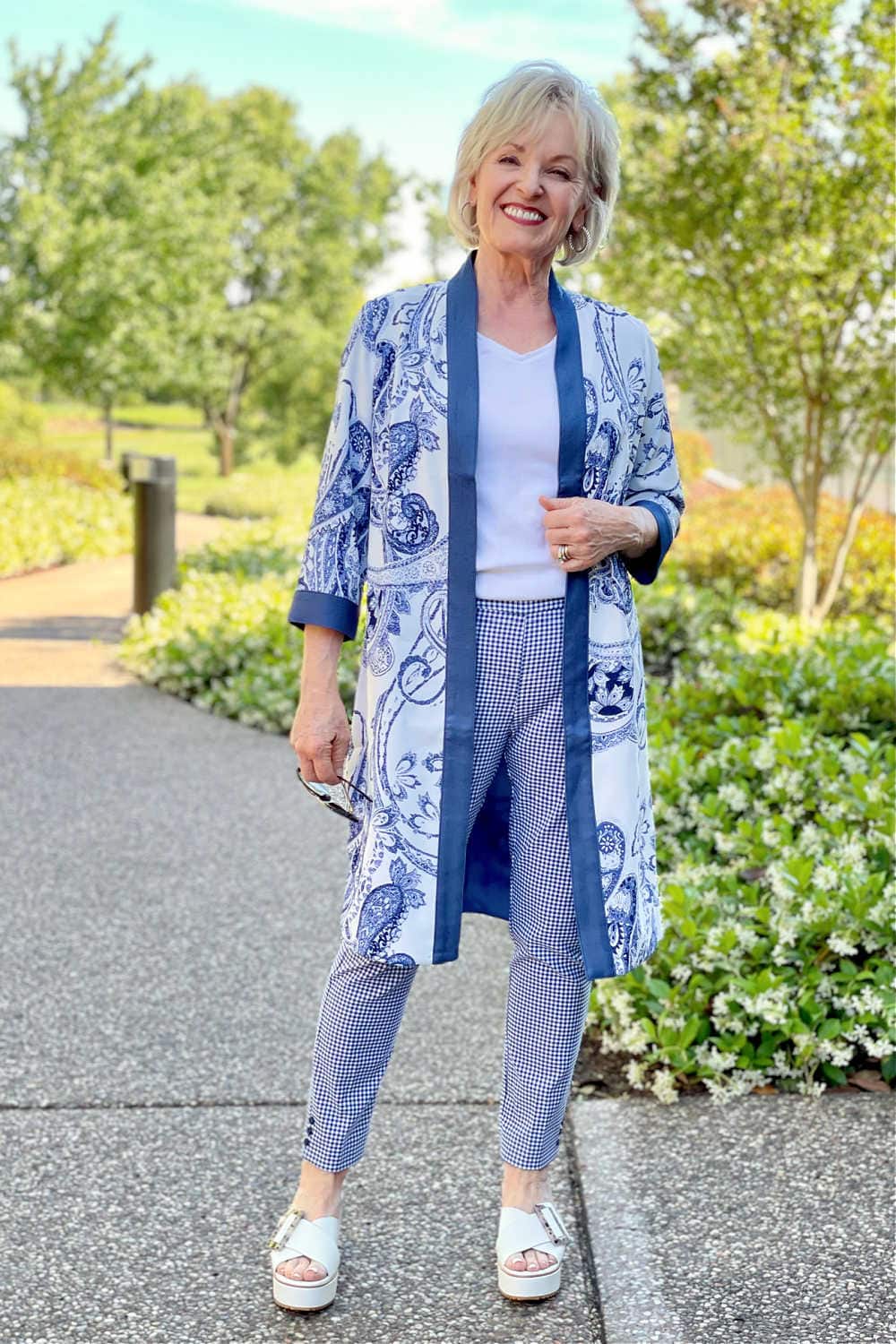 woman on path wearing blue gingham pants and blue kimono