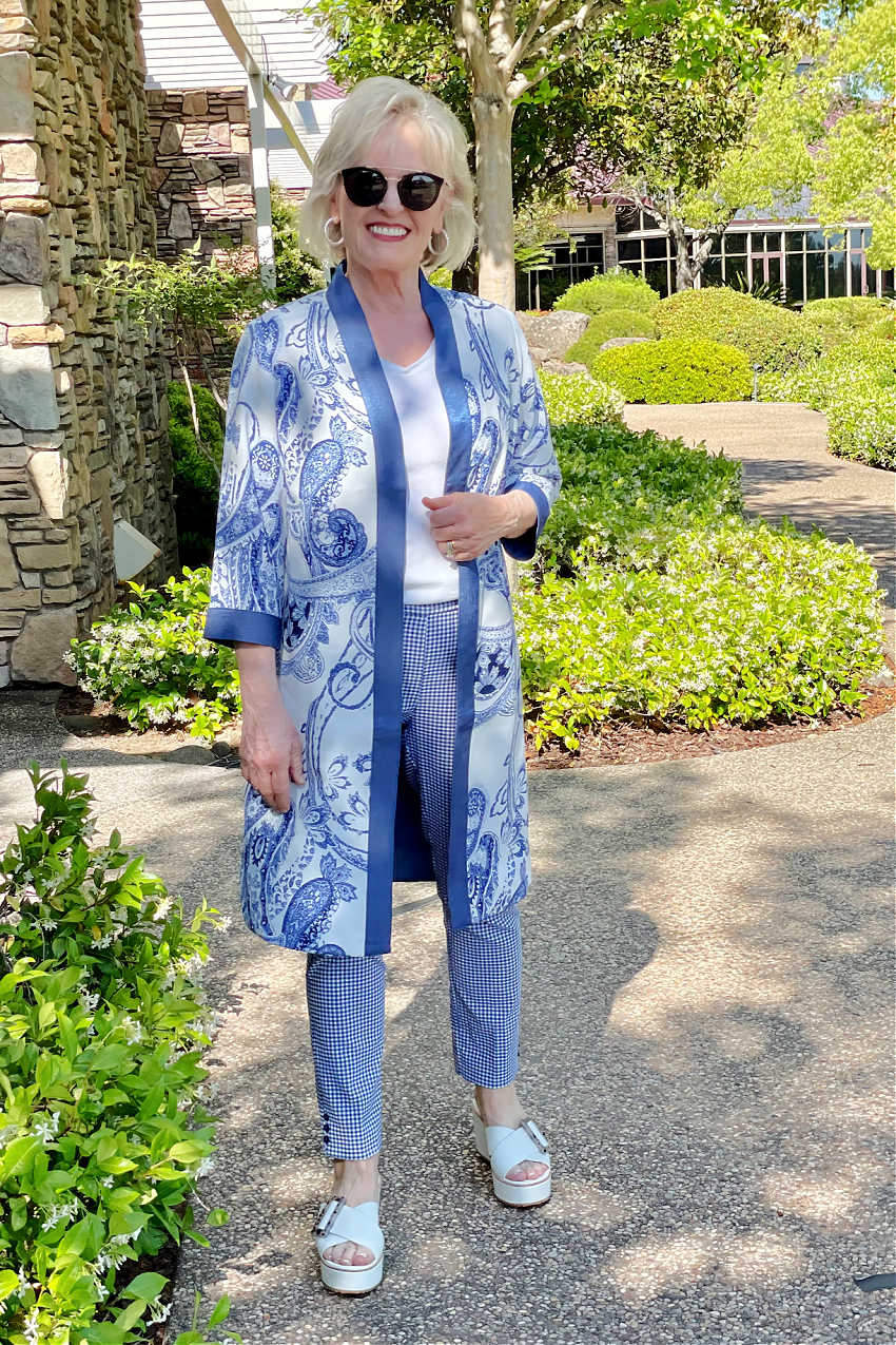 blonde woman looking at camera wearign kimono and pants in blue and white