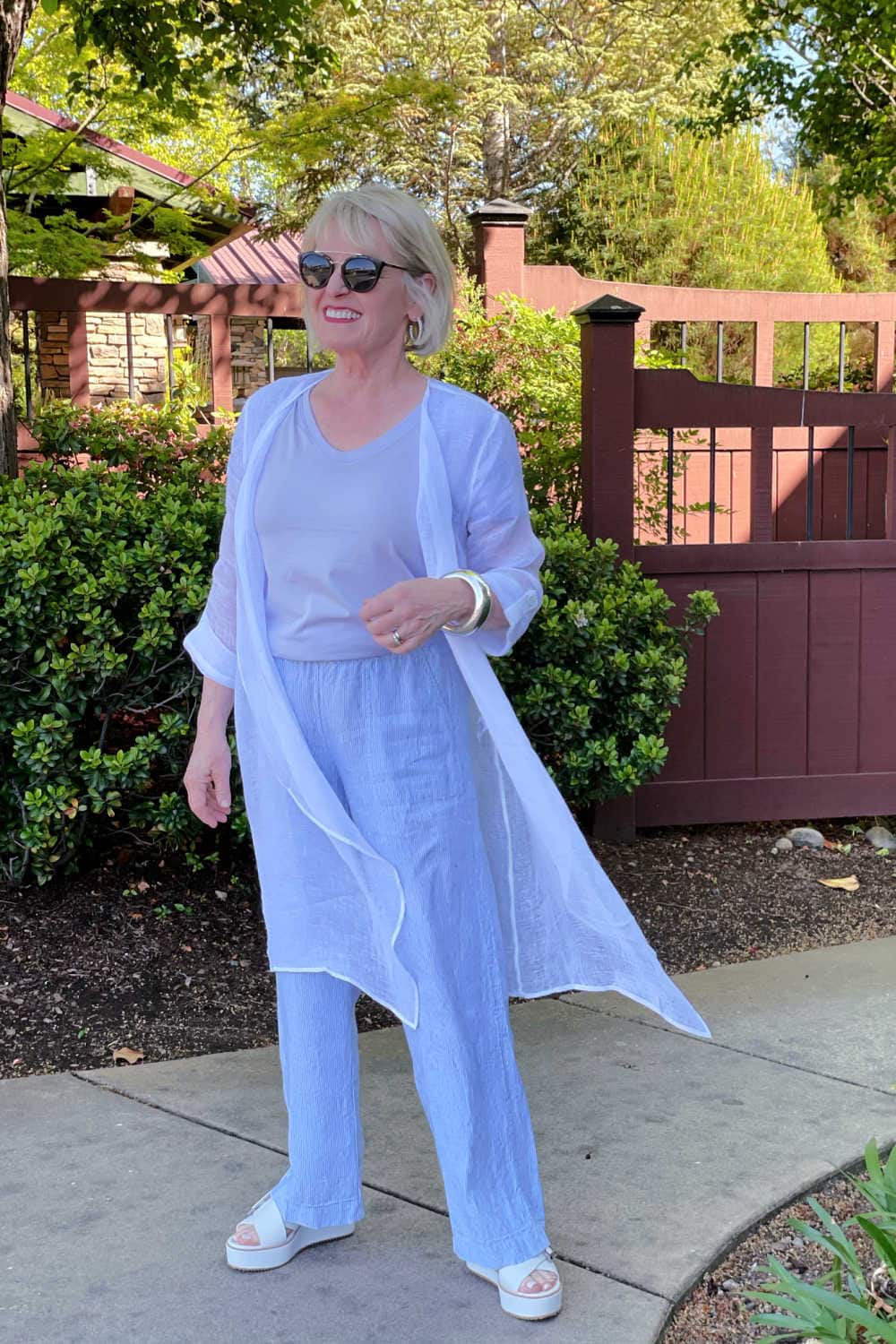 woman wearing linen duster with striped linen pants
