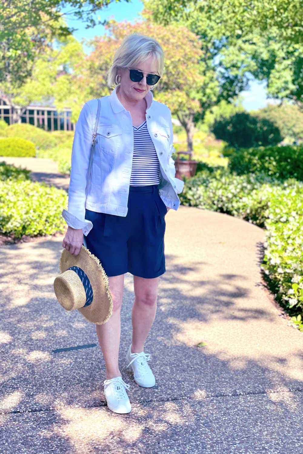 over 50 woman wearing pleated shorts and denim jacket