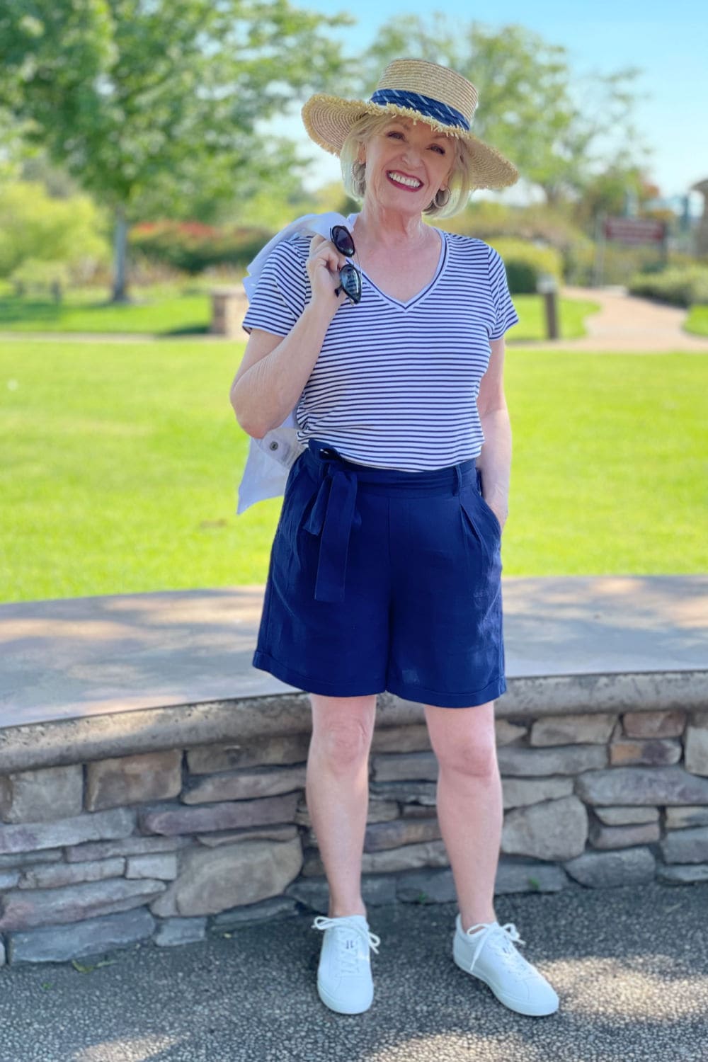 blond women over 60 wearing striped tee and navy belted shorts