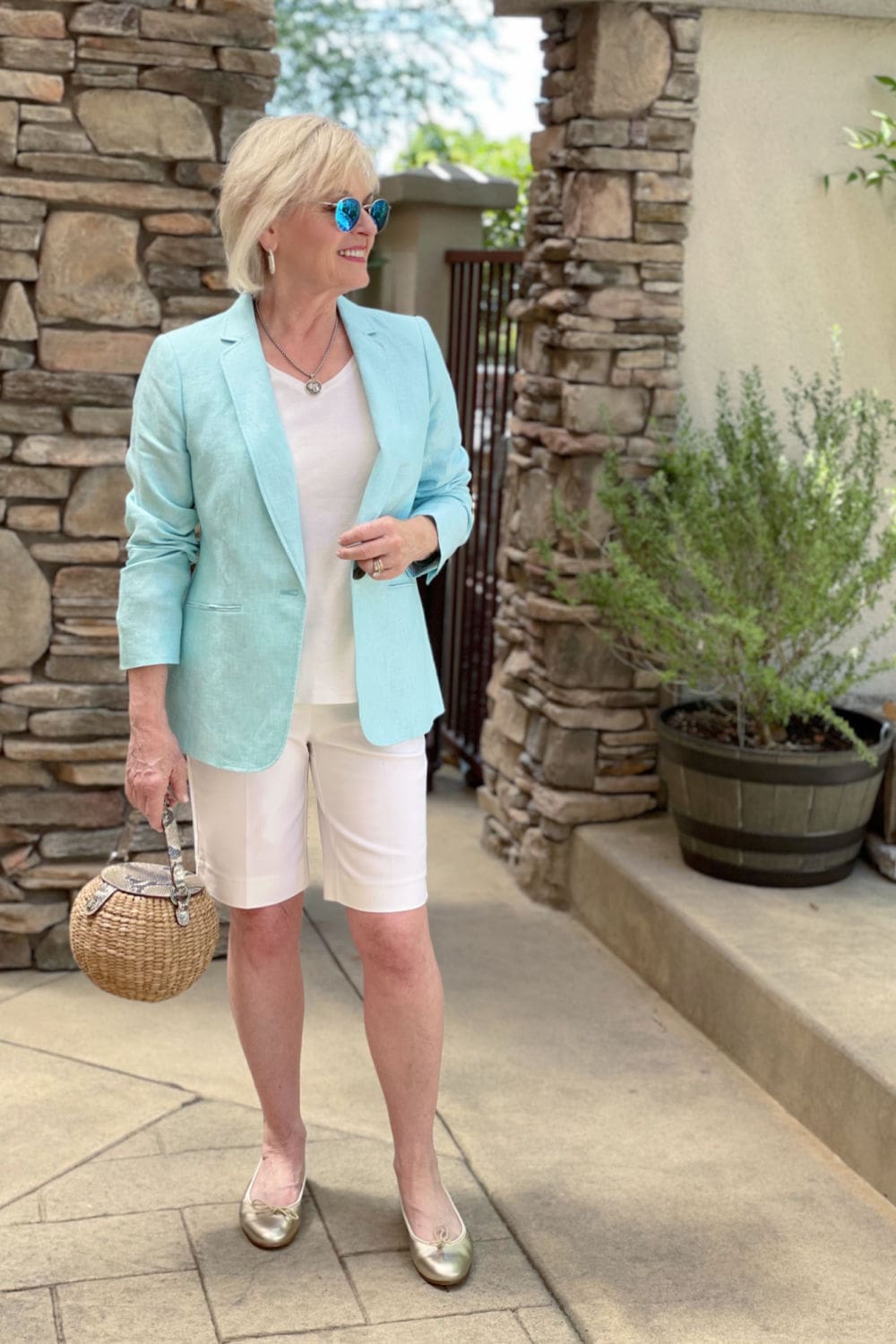 blonde woman wearing a blazer with shorts outfit plus metallic shoes