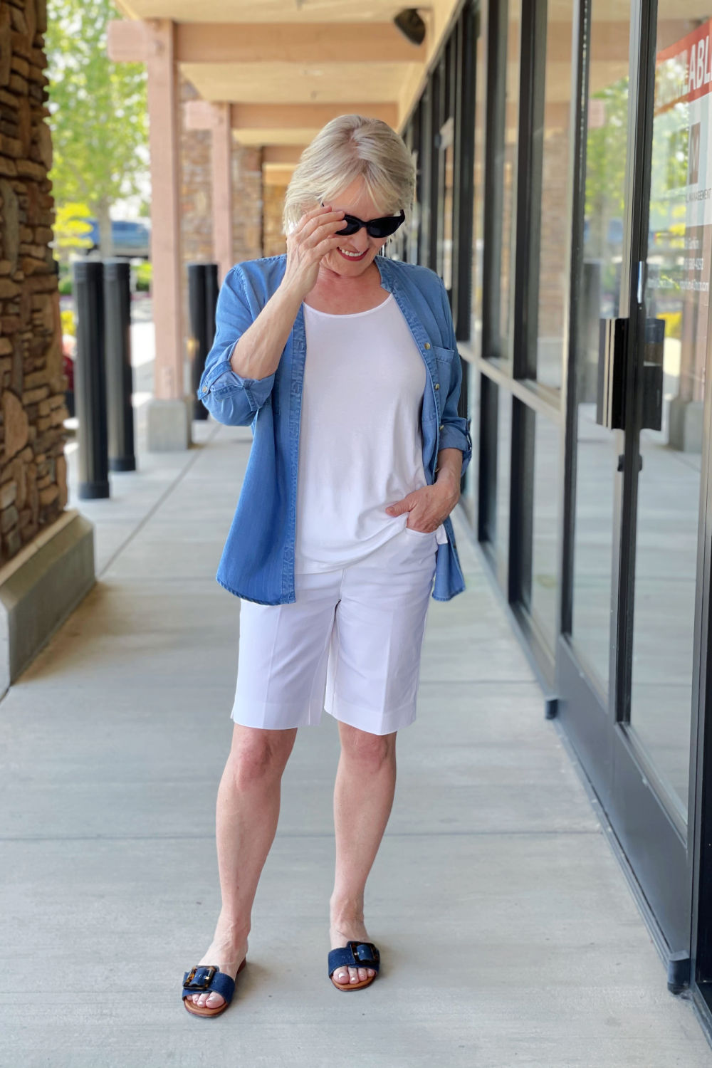 woman wearign white tee, white shorts and denim shirt