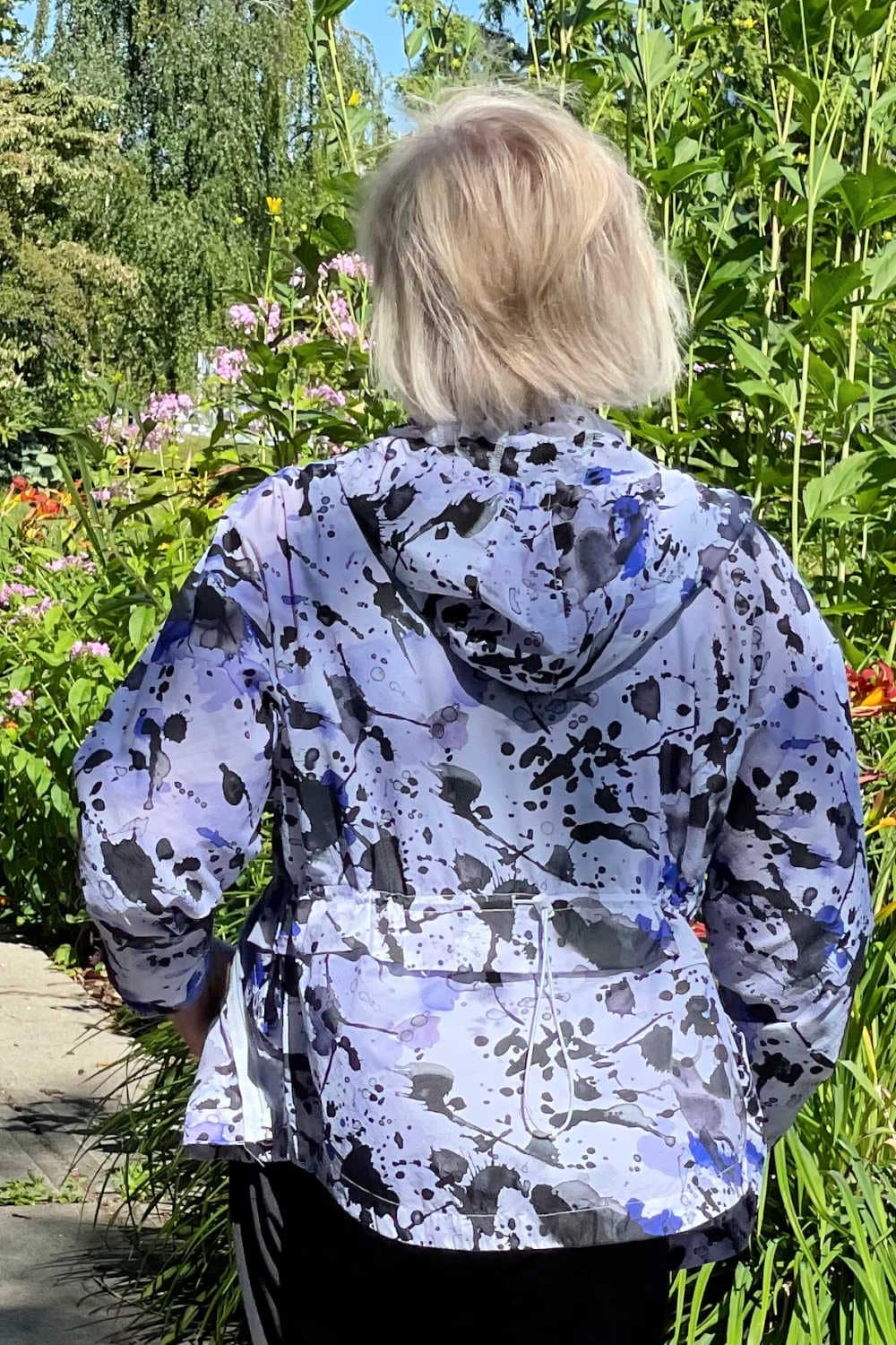 woman looking away showing back of zip hoodie