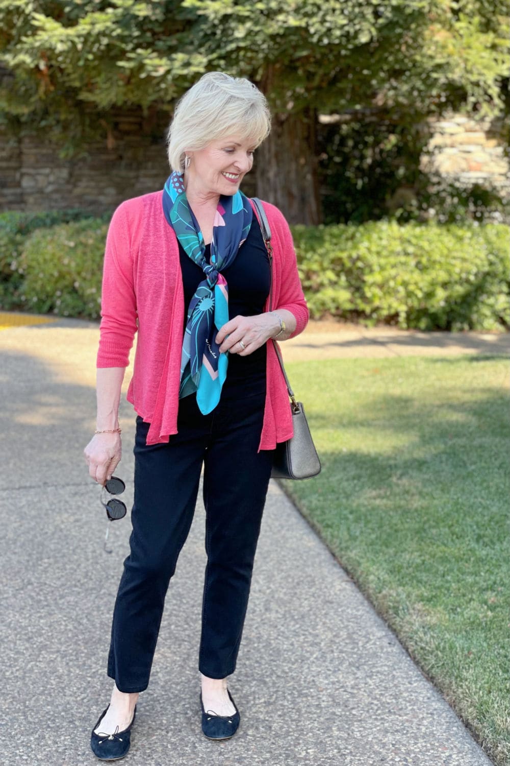 over 50 blogger jennifer connolly showing how to wear a colorful cardigan for later in the fall