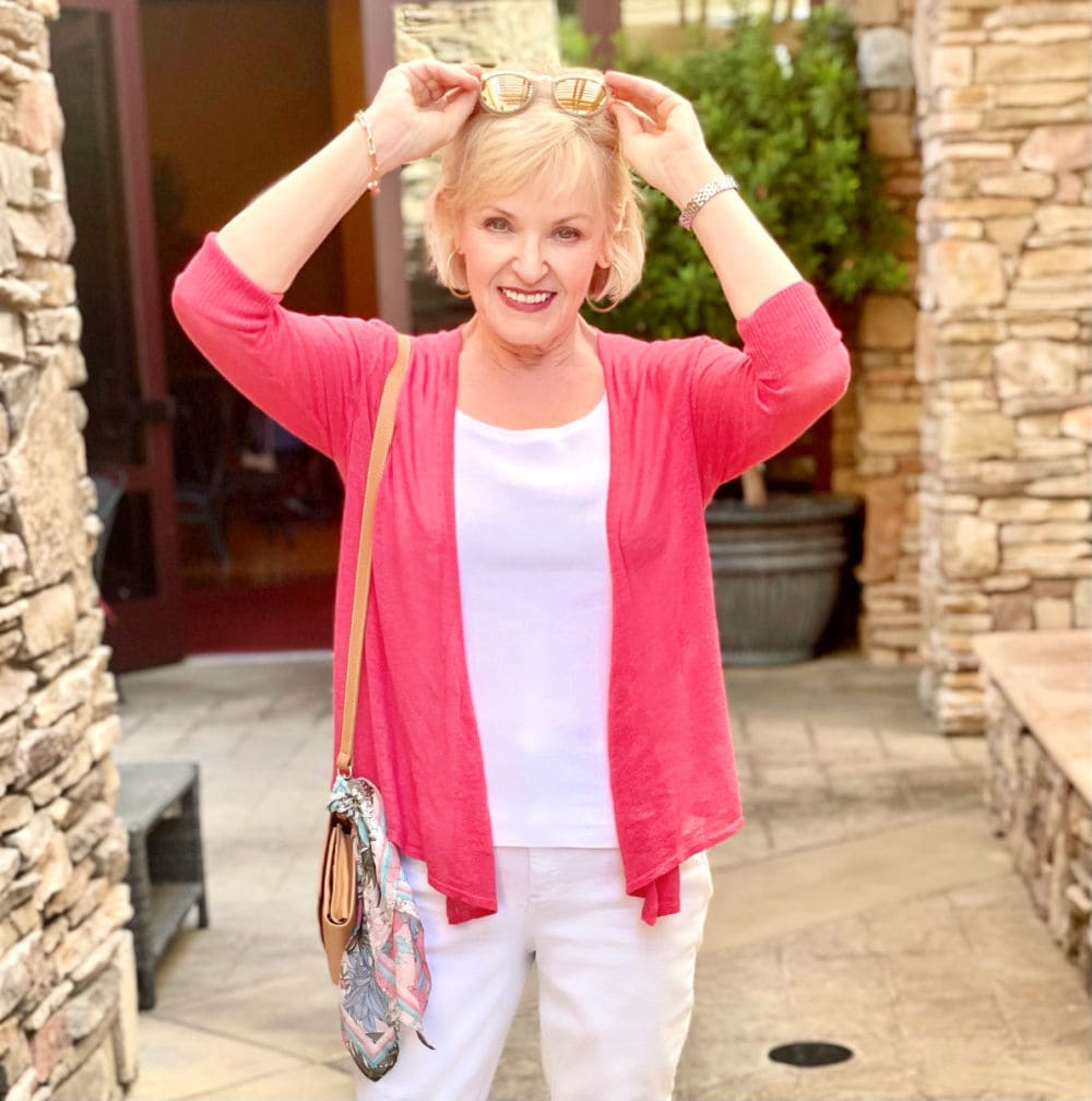 over 50 fashion blogger wearing pink sweater over white tank top