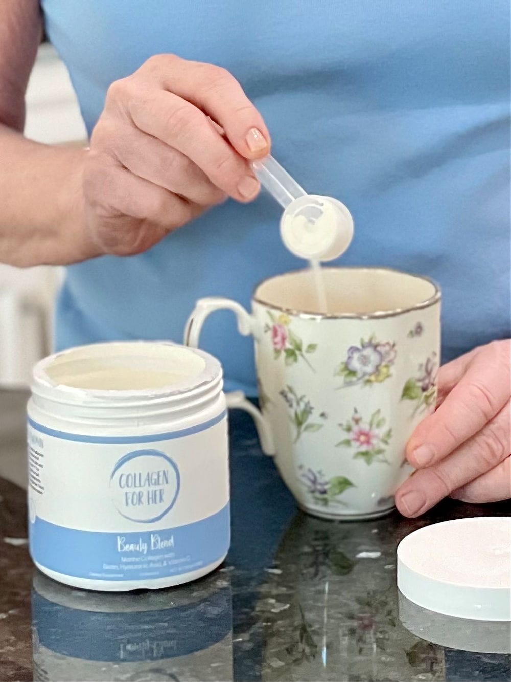 scooping pouring collagen for her powder into tea cup