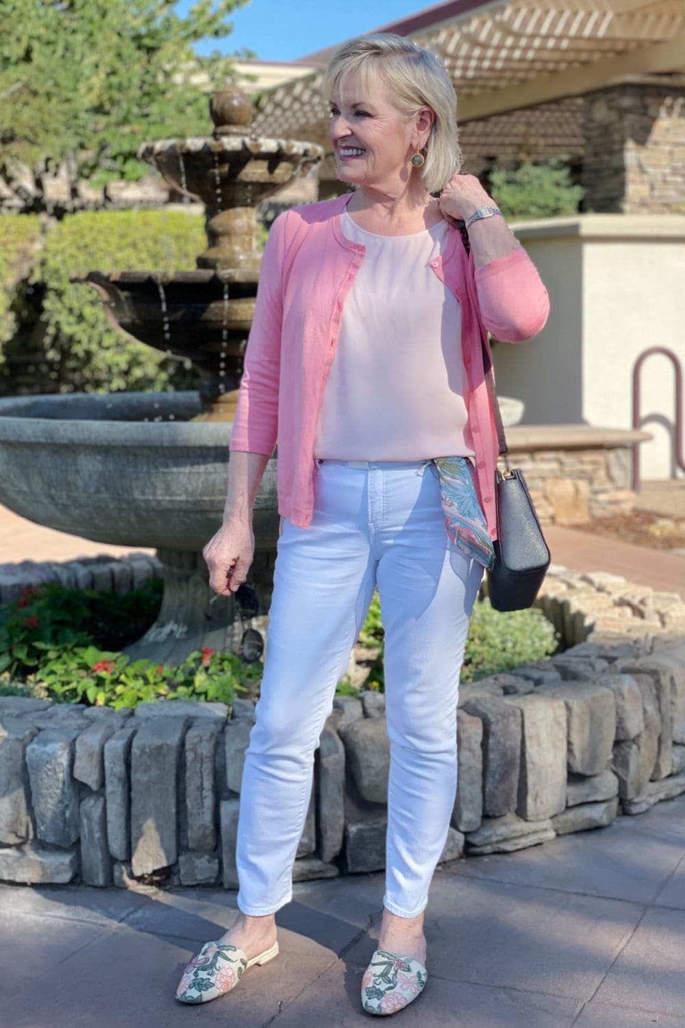 over 50 blogger jennifer of a well styled life wearing colors she loves in salmon, pink and white