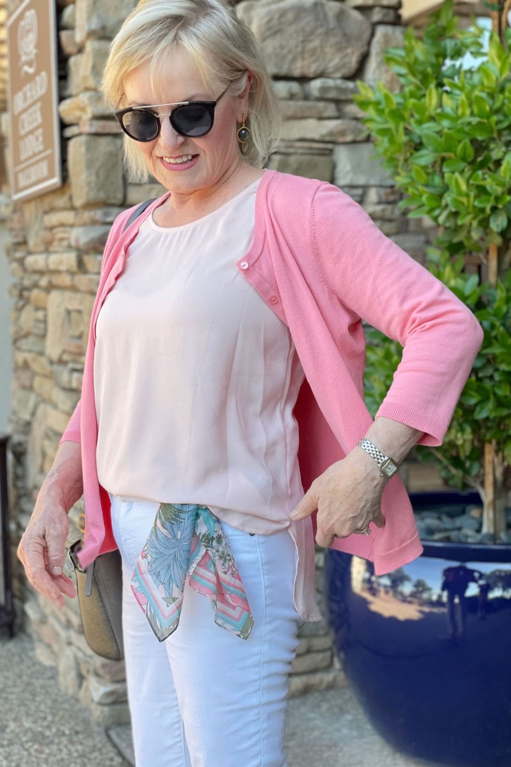 woman showing side view of half tucked shirt