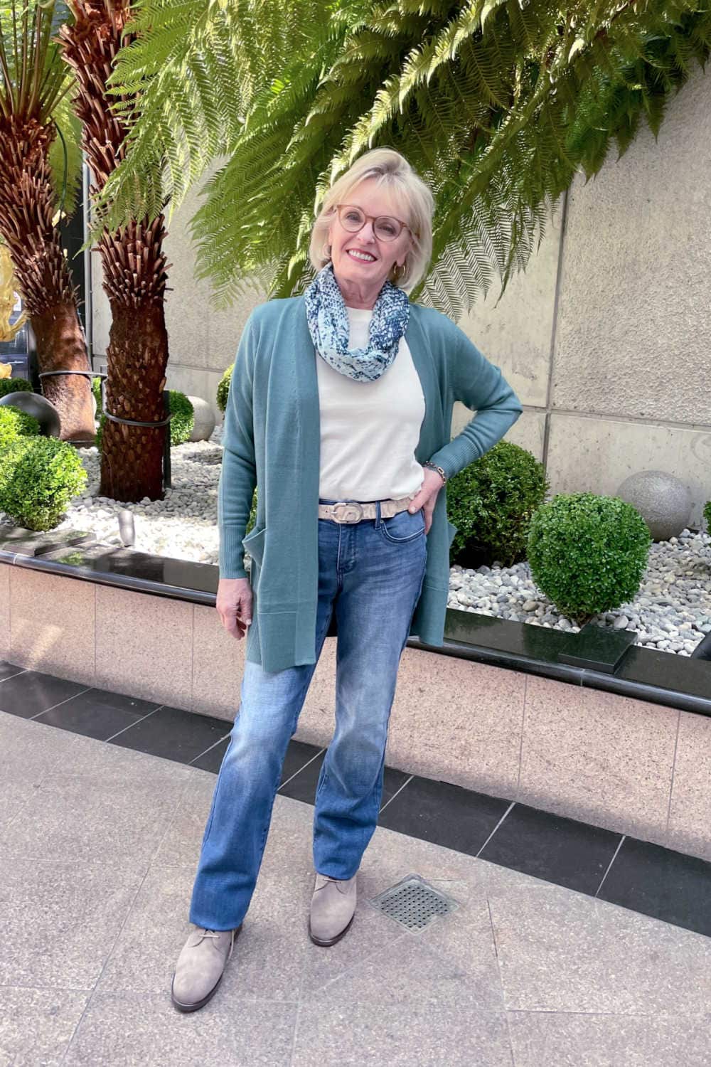 over 50 blogger wearing nordstrom sweater in teal over denim