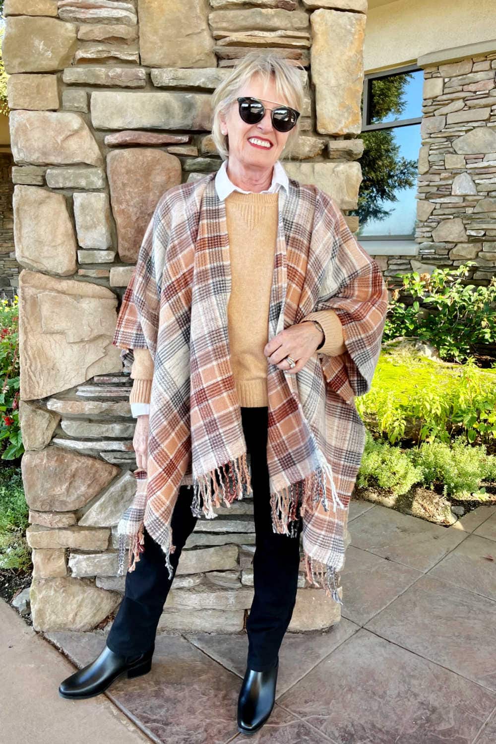 woman wearing stylish plaid wrap and black jeans from Target