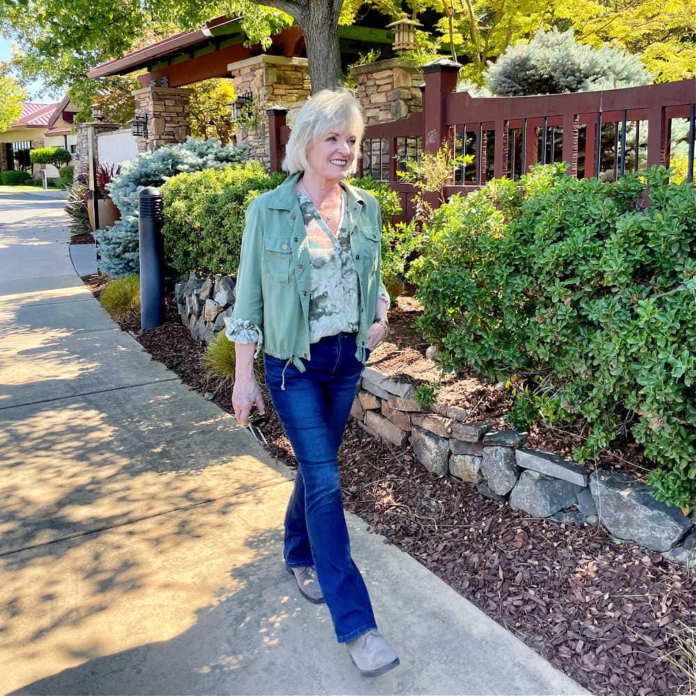 woman walking lightweight fall outfit of bootcut jeans and suede booties from Nordstrom