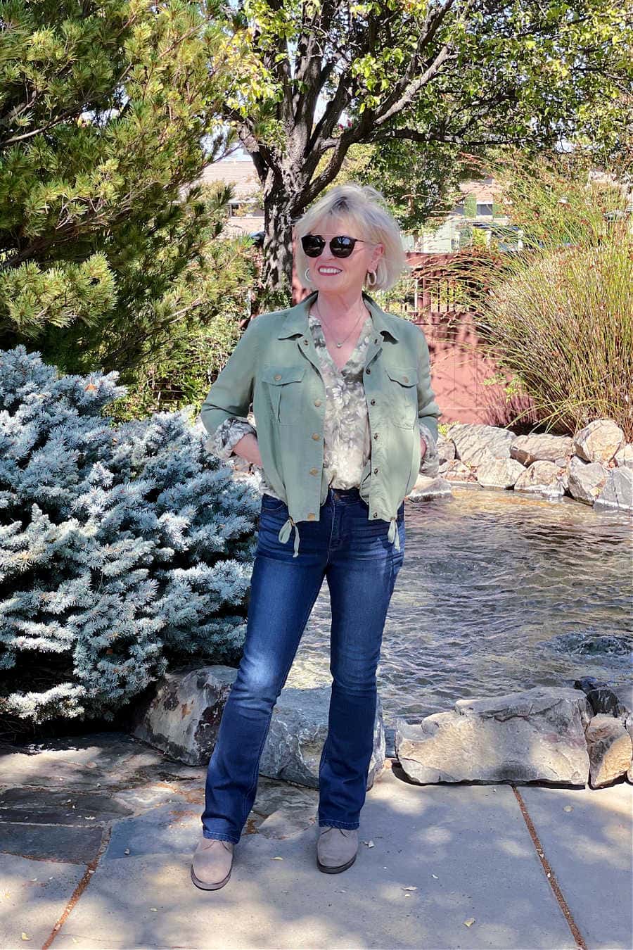 over 50 blogger wearing floral blouse, green jacket and jeans from Nordstrom