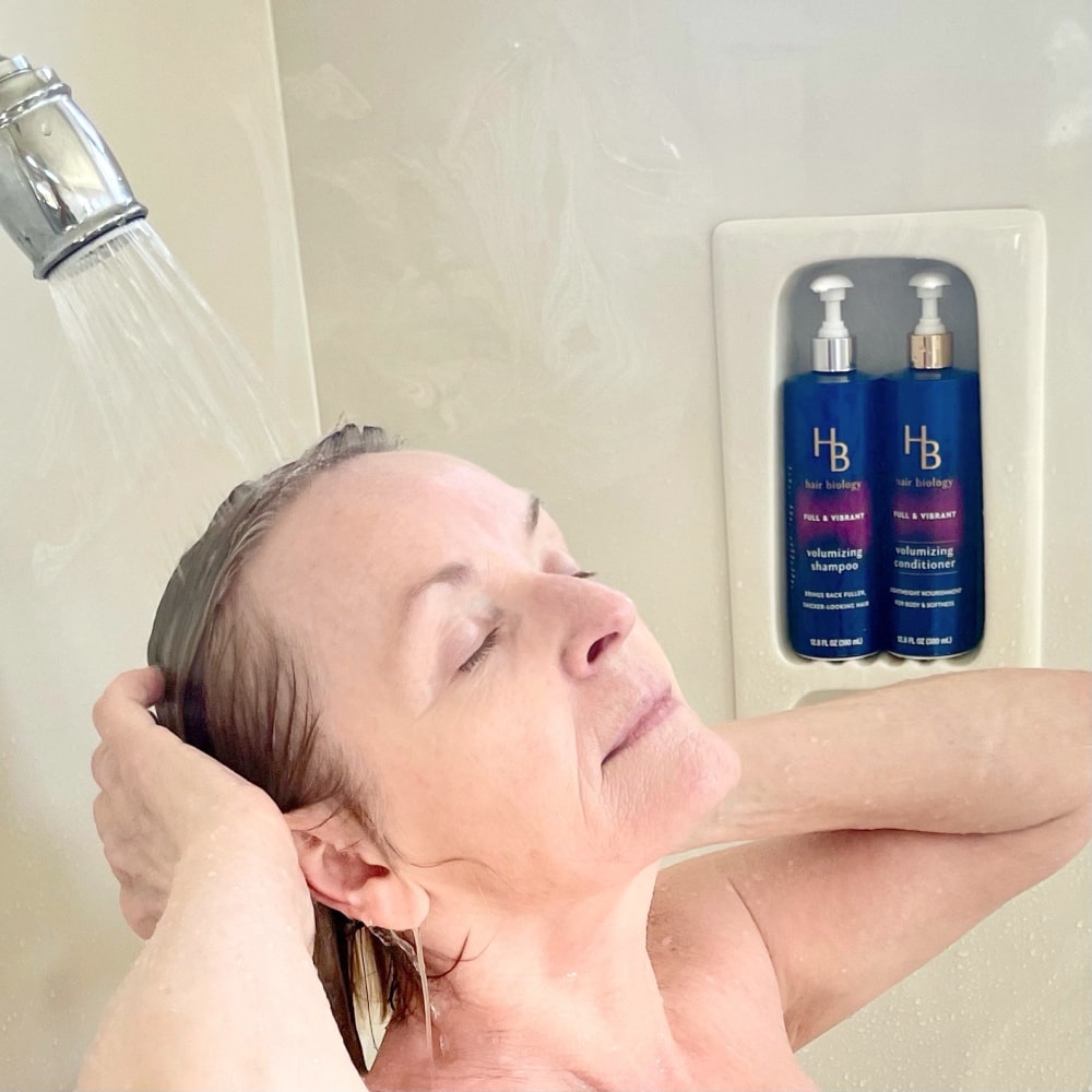 midlife woman washing hair in shower with thickening shampoo