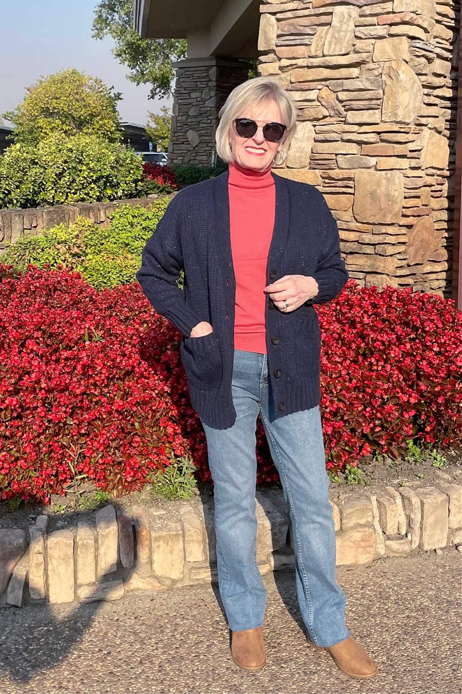 woman wearing free assembly sweater and jeans