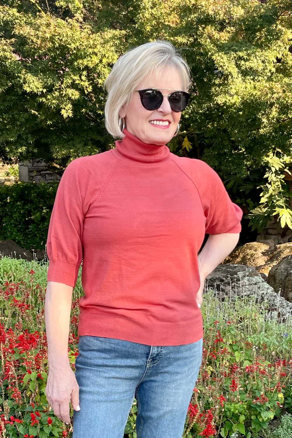 blonde woman wearing rust colored short sleeve turtleneck