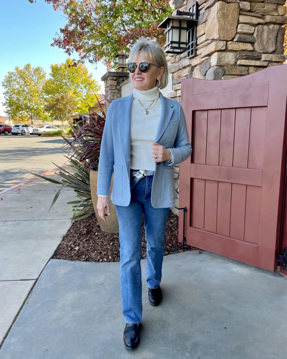older woman walking in jeans and jacket
