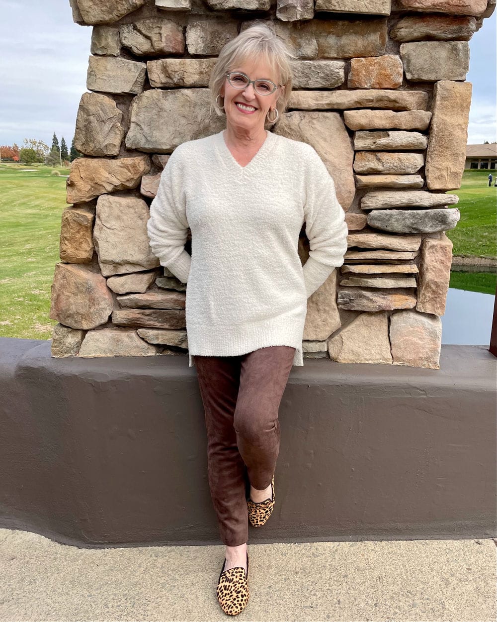 woman wearing cheetah flats and leggings with ivory tunic sweater