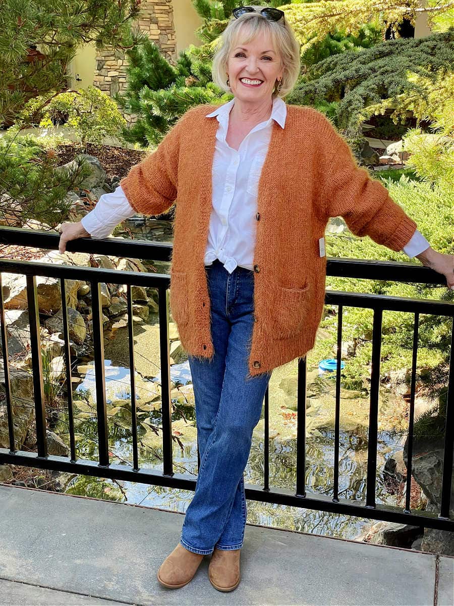 jennifer connolly wearing rust colored cardigan outfit