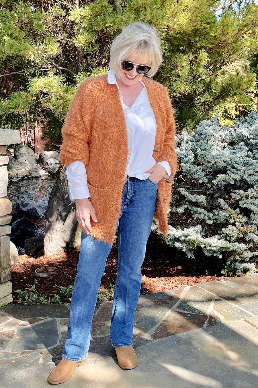 rust fuzzy cardigan, white shirt, blue jeans and chelsea boots