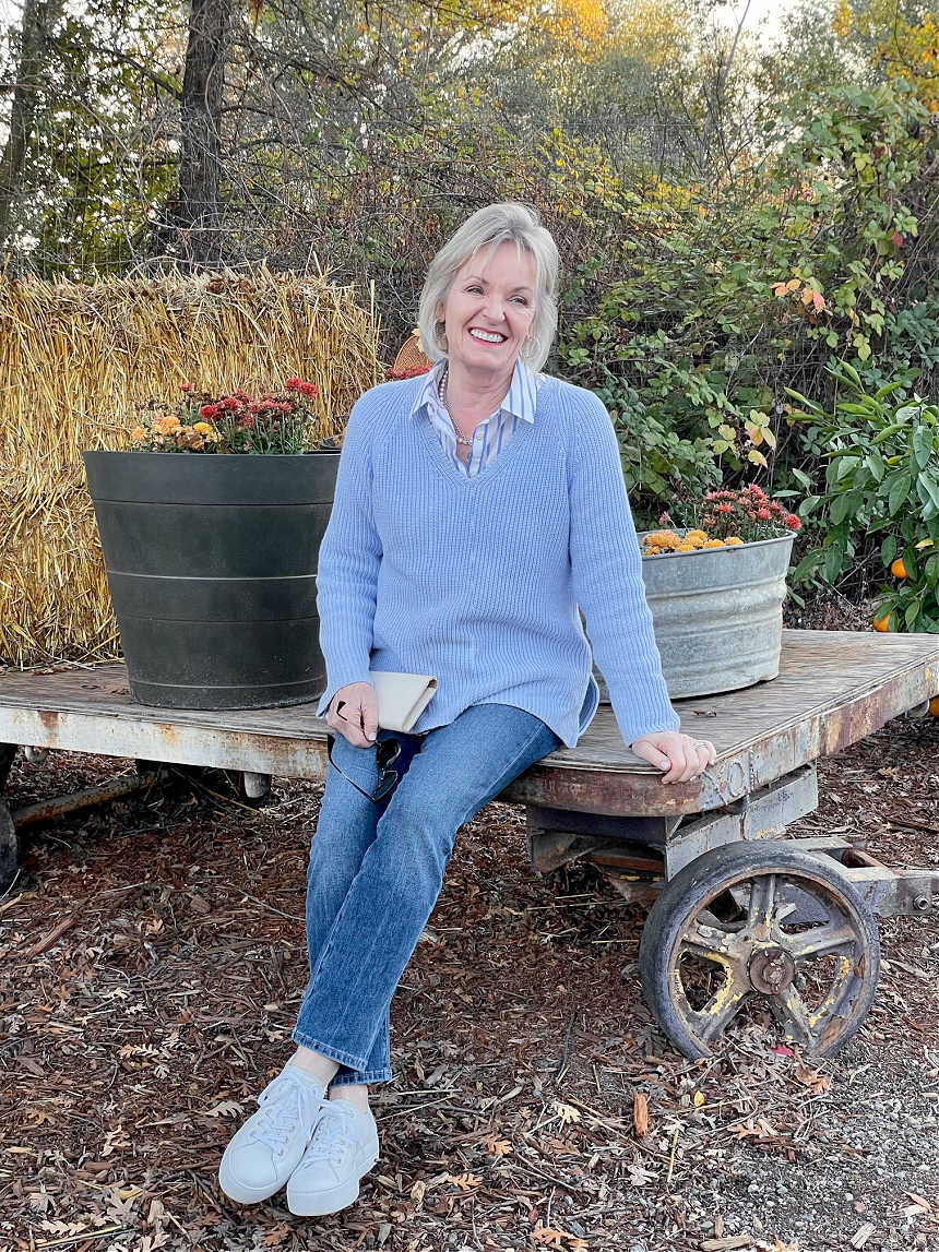 WOMAN SITTING ON WOODEN WAGON