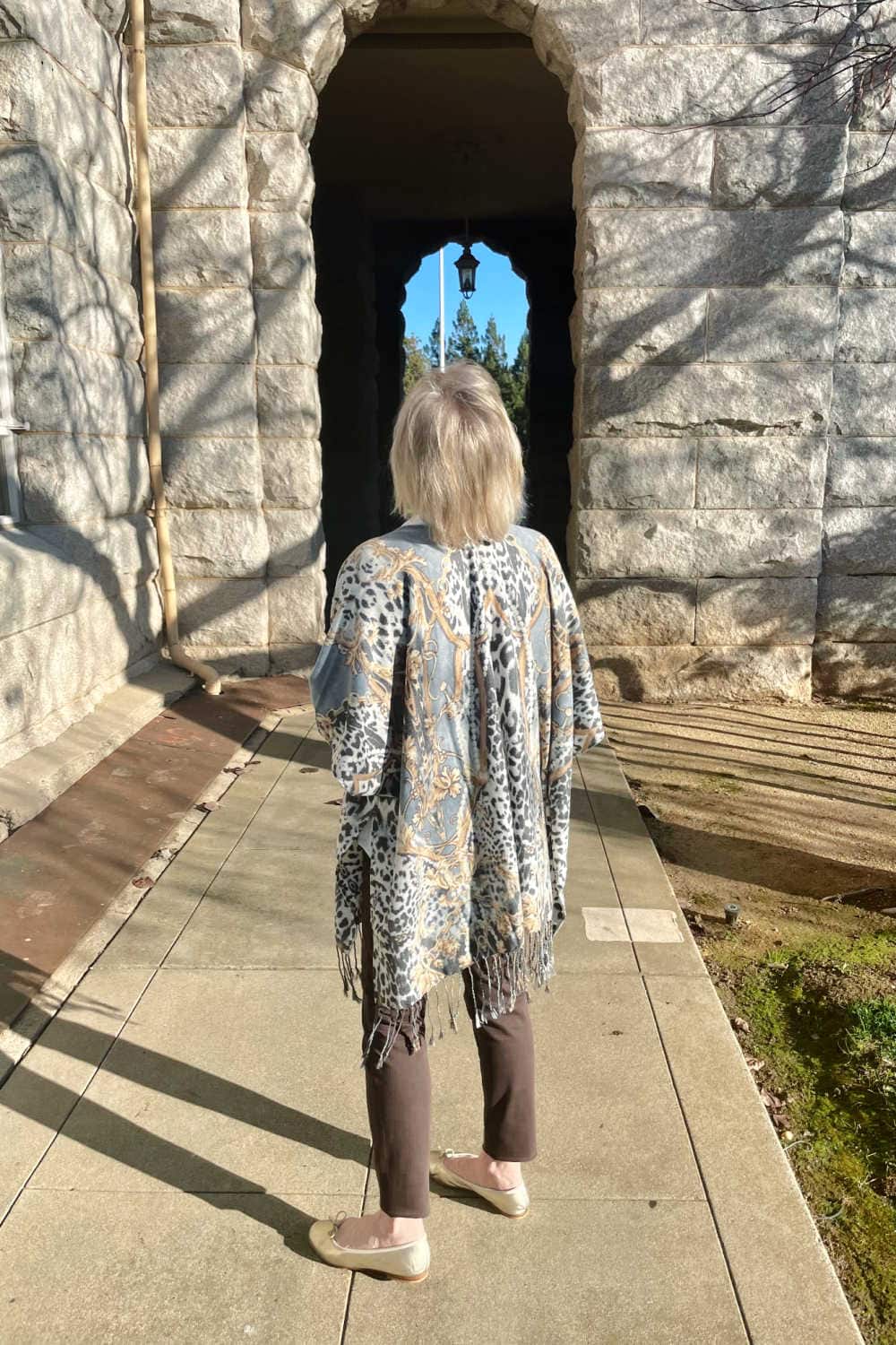 woman showing back of soft animal print ruana
