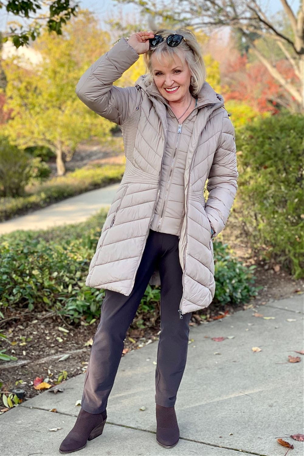 woman standing with bib of jacket showing