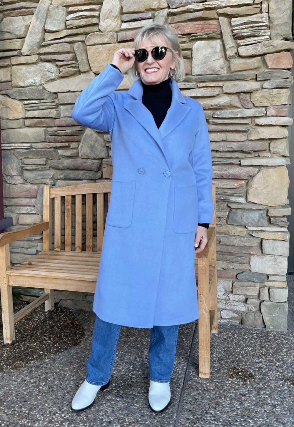 blonde woman wearing blue halogen coat and jeans