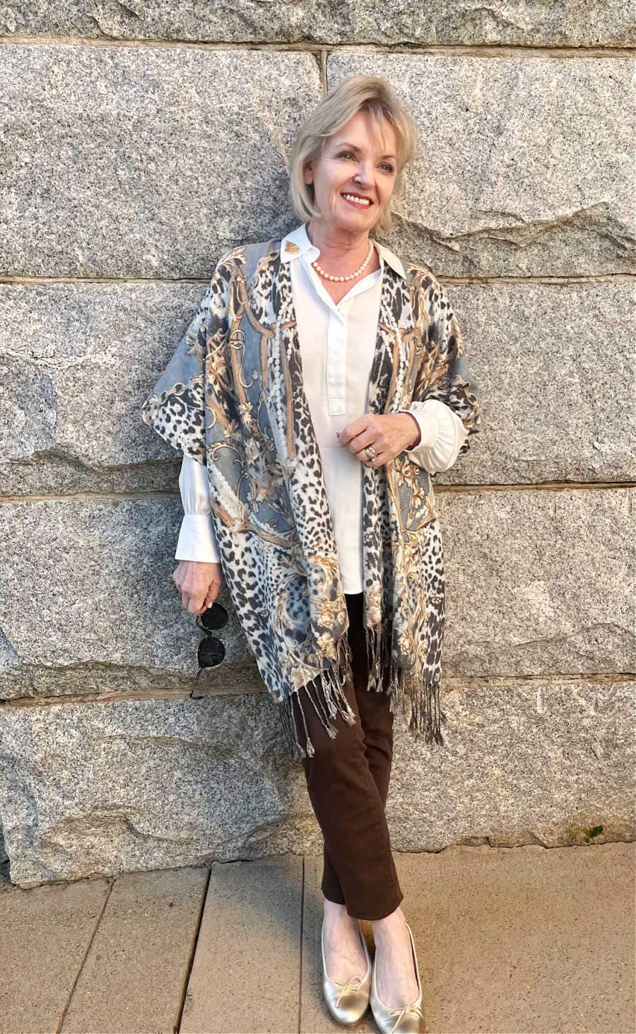 woman wearing soft brown jeans and muted colored kimono