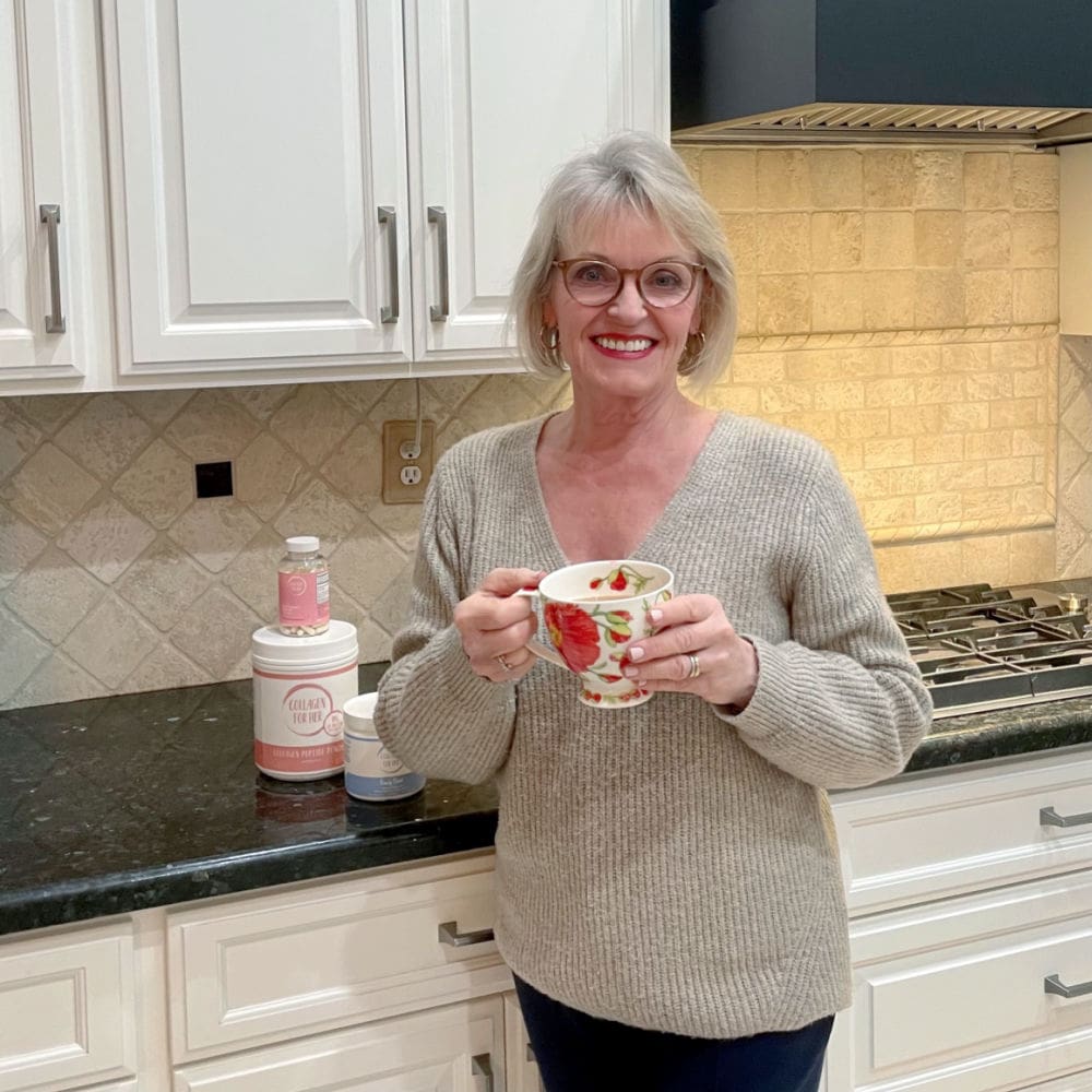 woman drinking tea with collagen powder in it