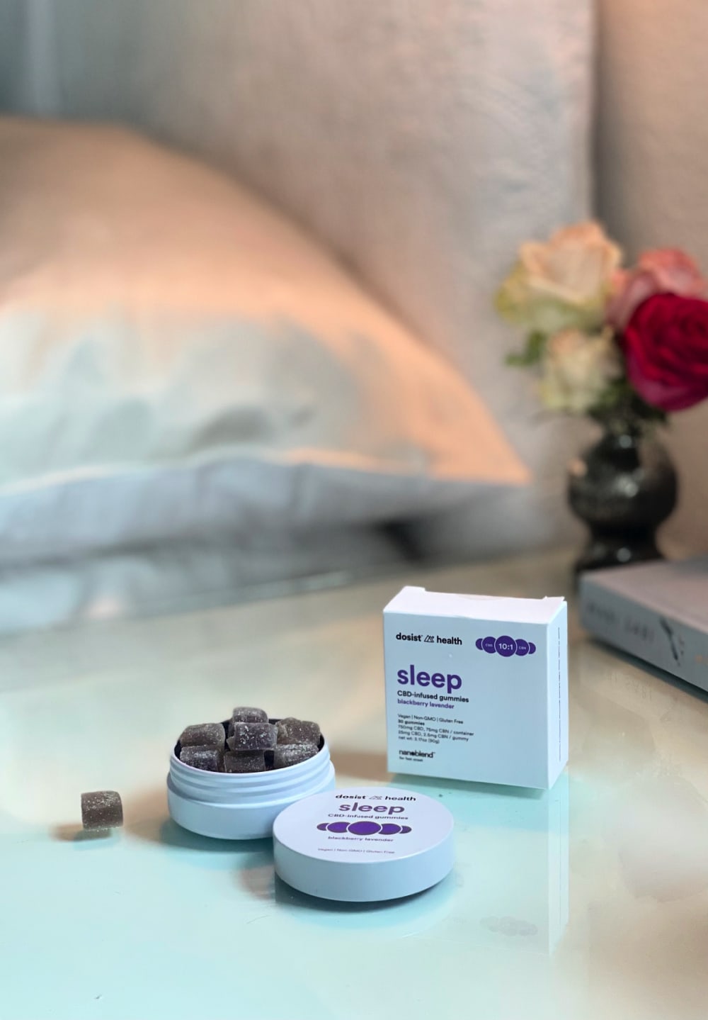 dosist health sleep cbd+ gummy tin on bedside table