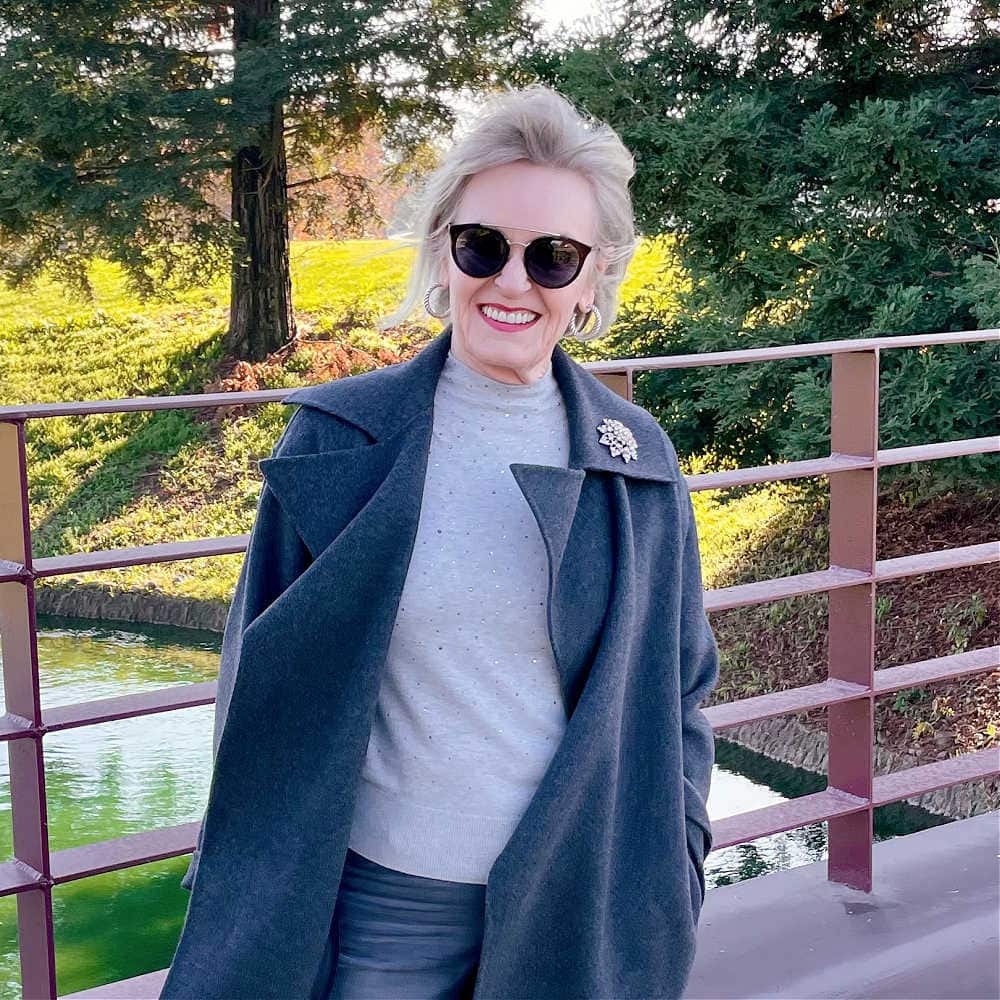 woman wearing modern gray sweater and simple accessories