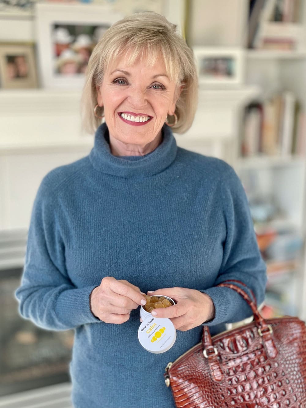 woman holding tin of calm cbd+ dummies from dosist health