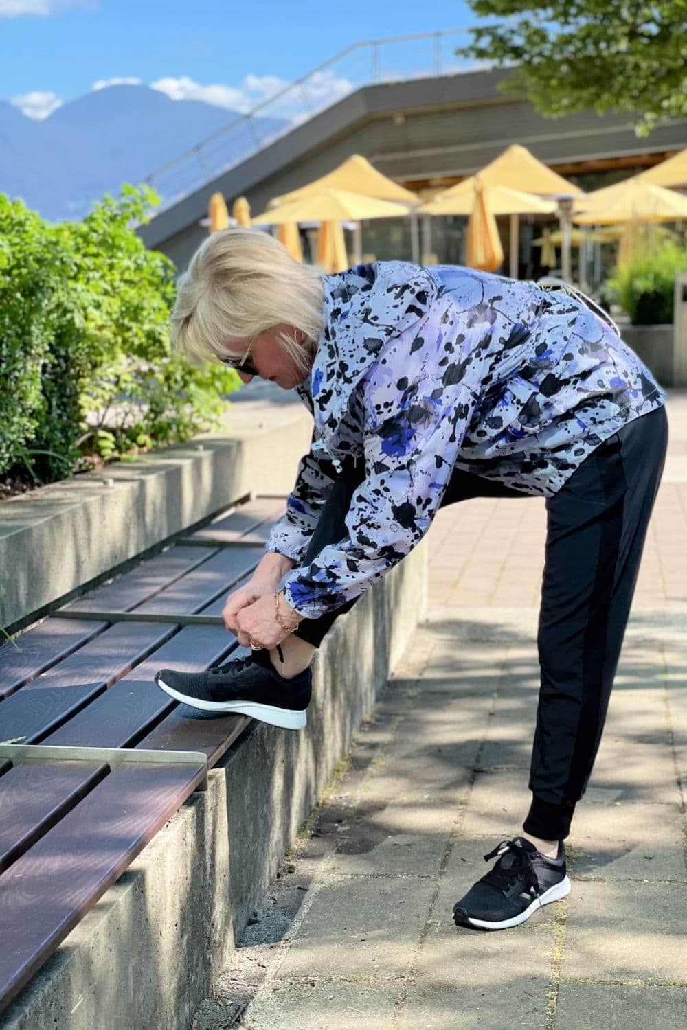 woman tying laces on sneakers
