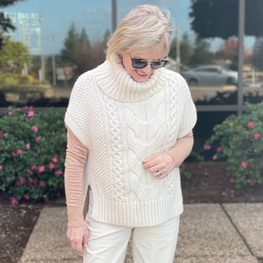 woman wearing neutral cabled vest