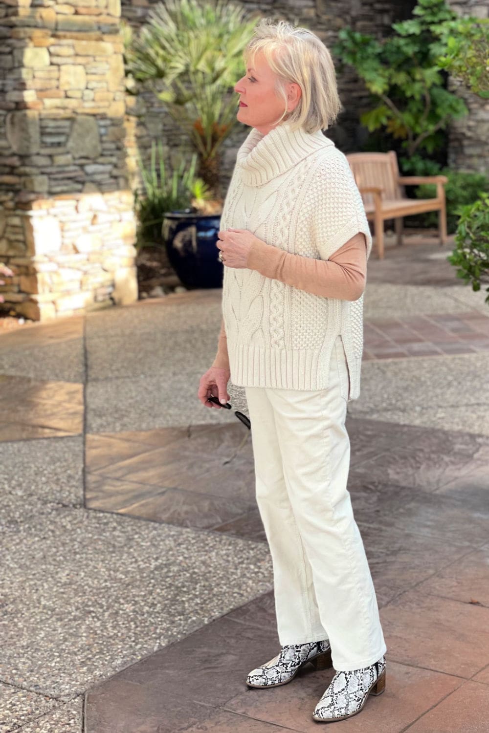 blonde woman wearing cabled vest