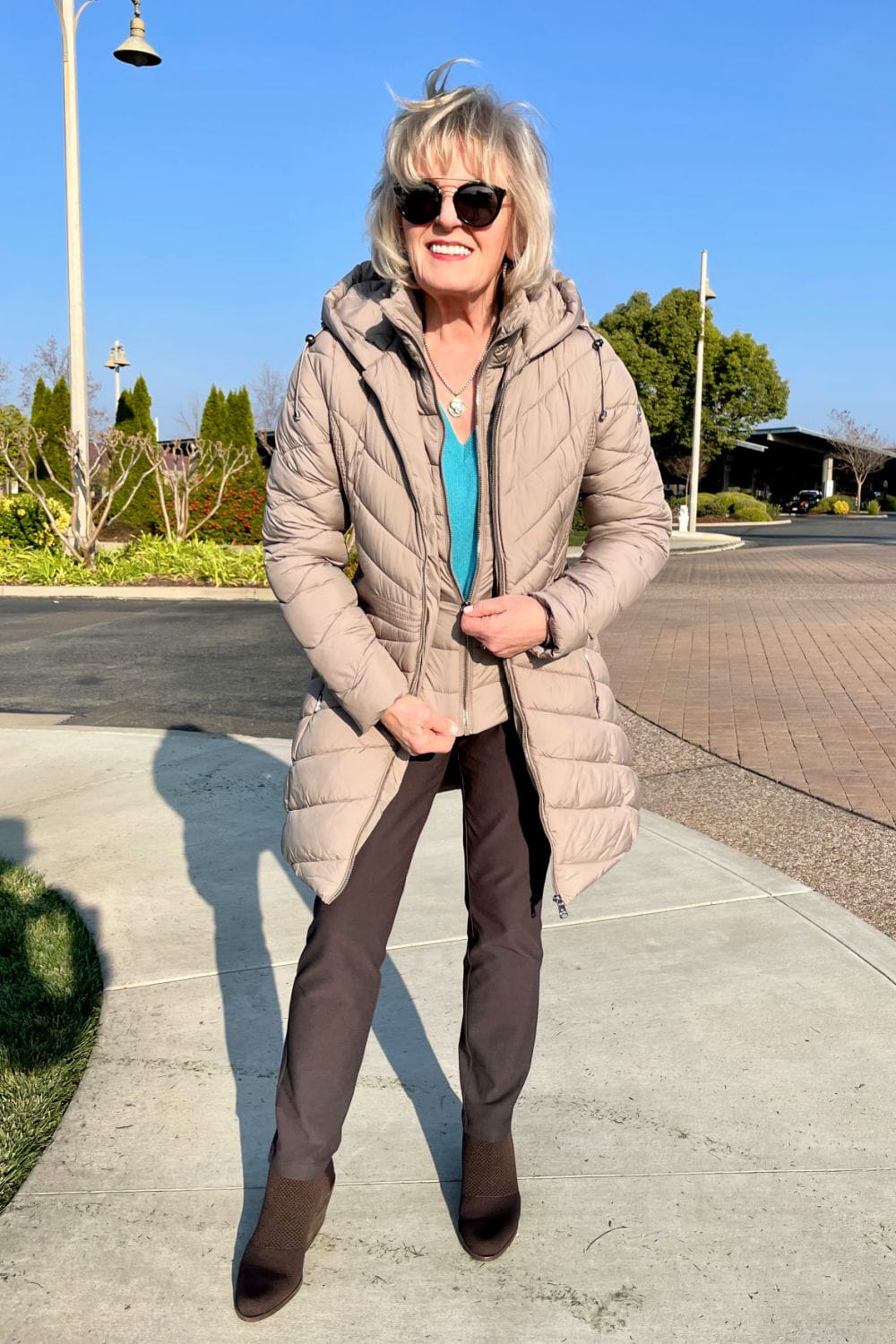 women zipping up bib on eco plume coat
