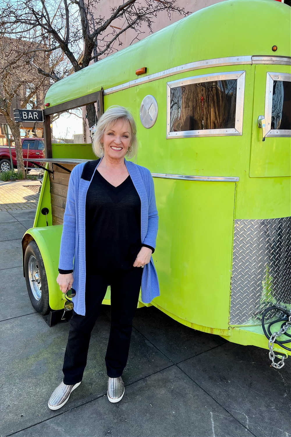 WOMAN STANDING IN FRONT OF GREEN TRAILER