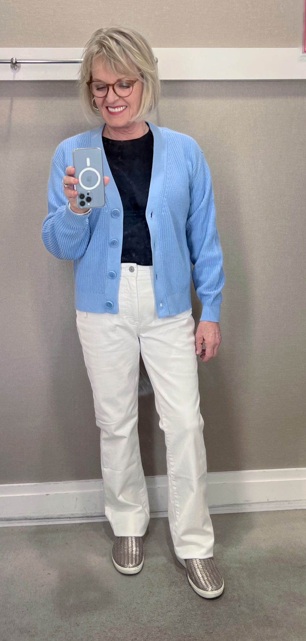 WOMAN WEARING WHITE JEANS AND BLUE CARDIGAN