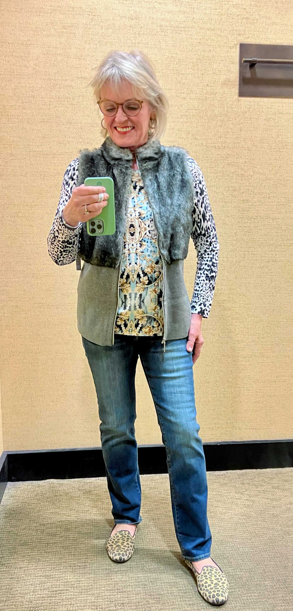 woman wearing faux fur vest and jeans