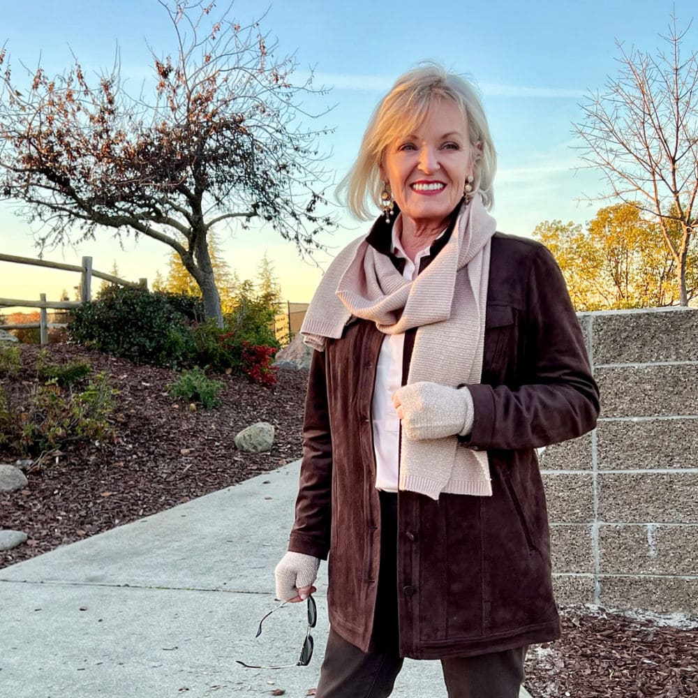 woman in brown jacket and texured scarf