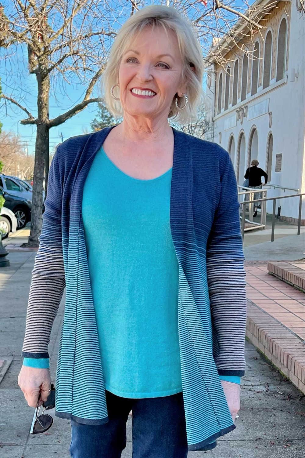 woman wearing sweater and striped cardigan