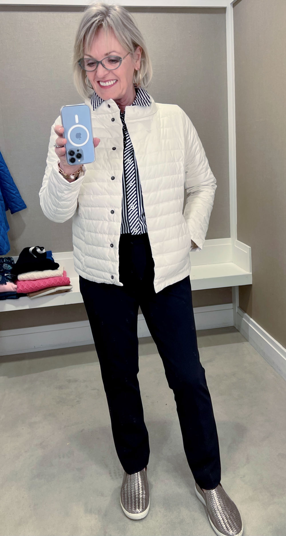 woman wearing navy pants and puffer jacket