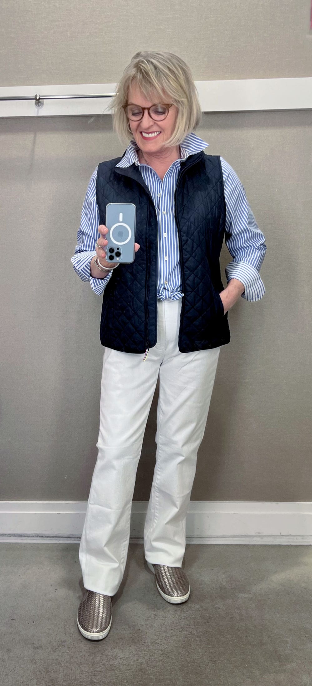 woman wearing blue striped shirt and white jeans