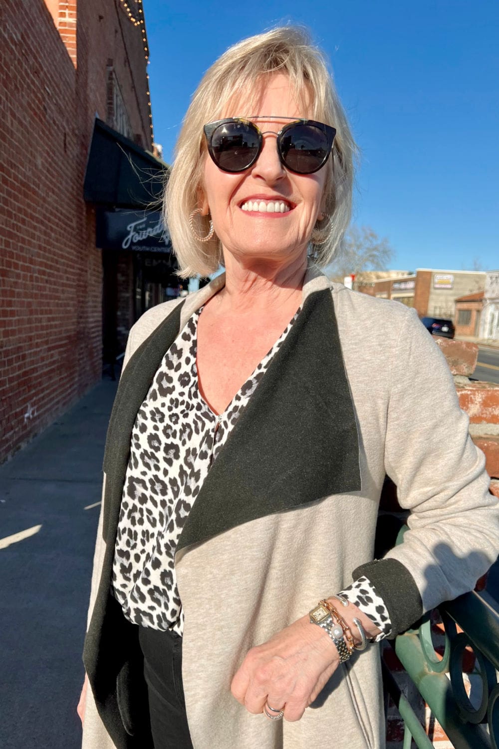 woman wearing leopard blouse and silver jewelry