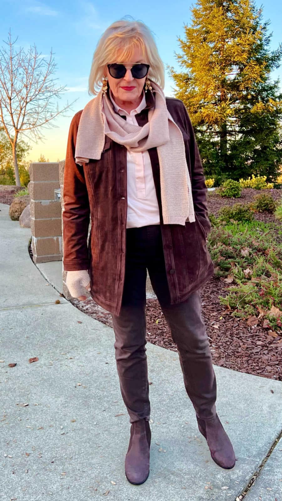 silver haired womkan wearing brown jeans and jacket