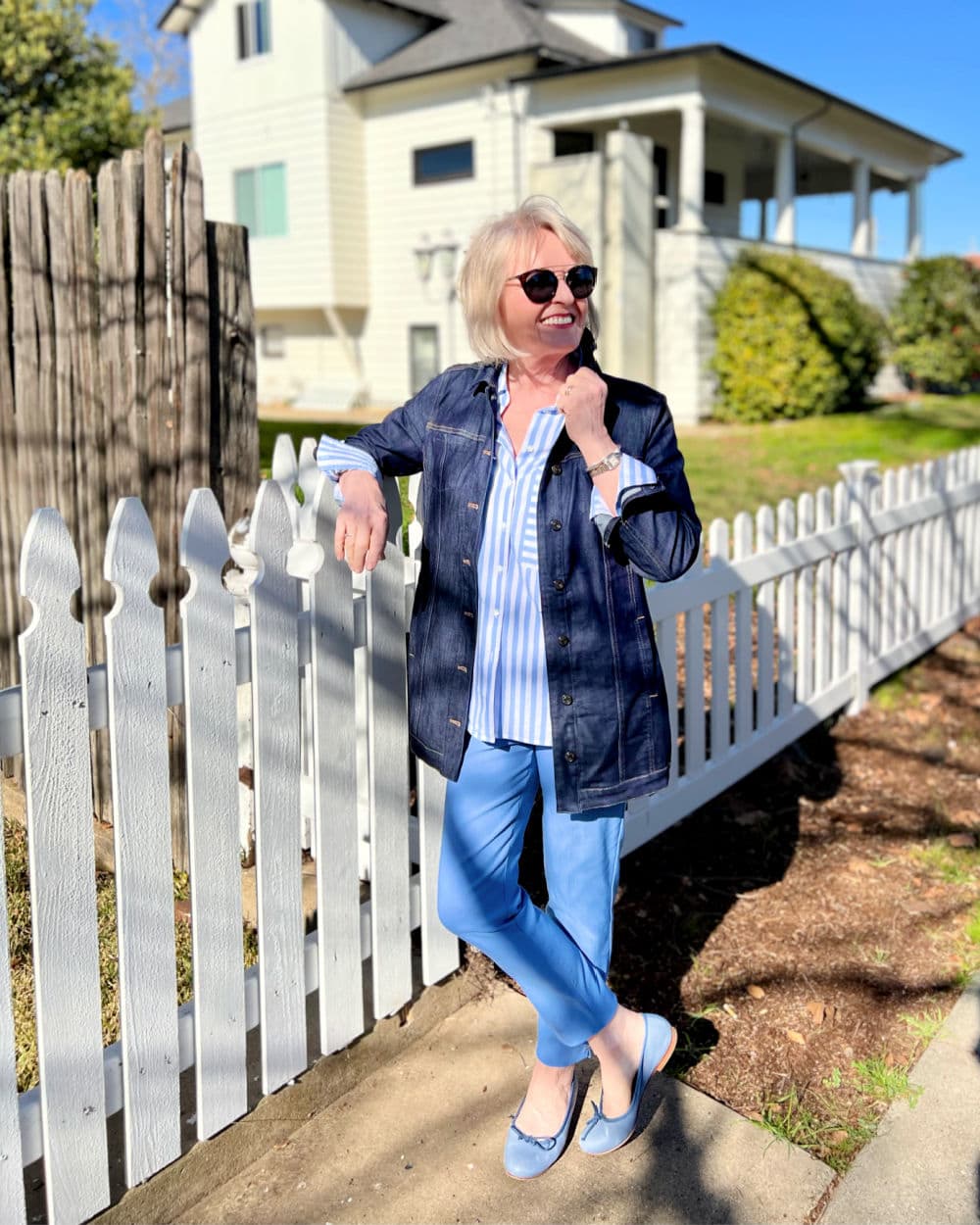 woman wearing elongated denim jacket with striped shirt