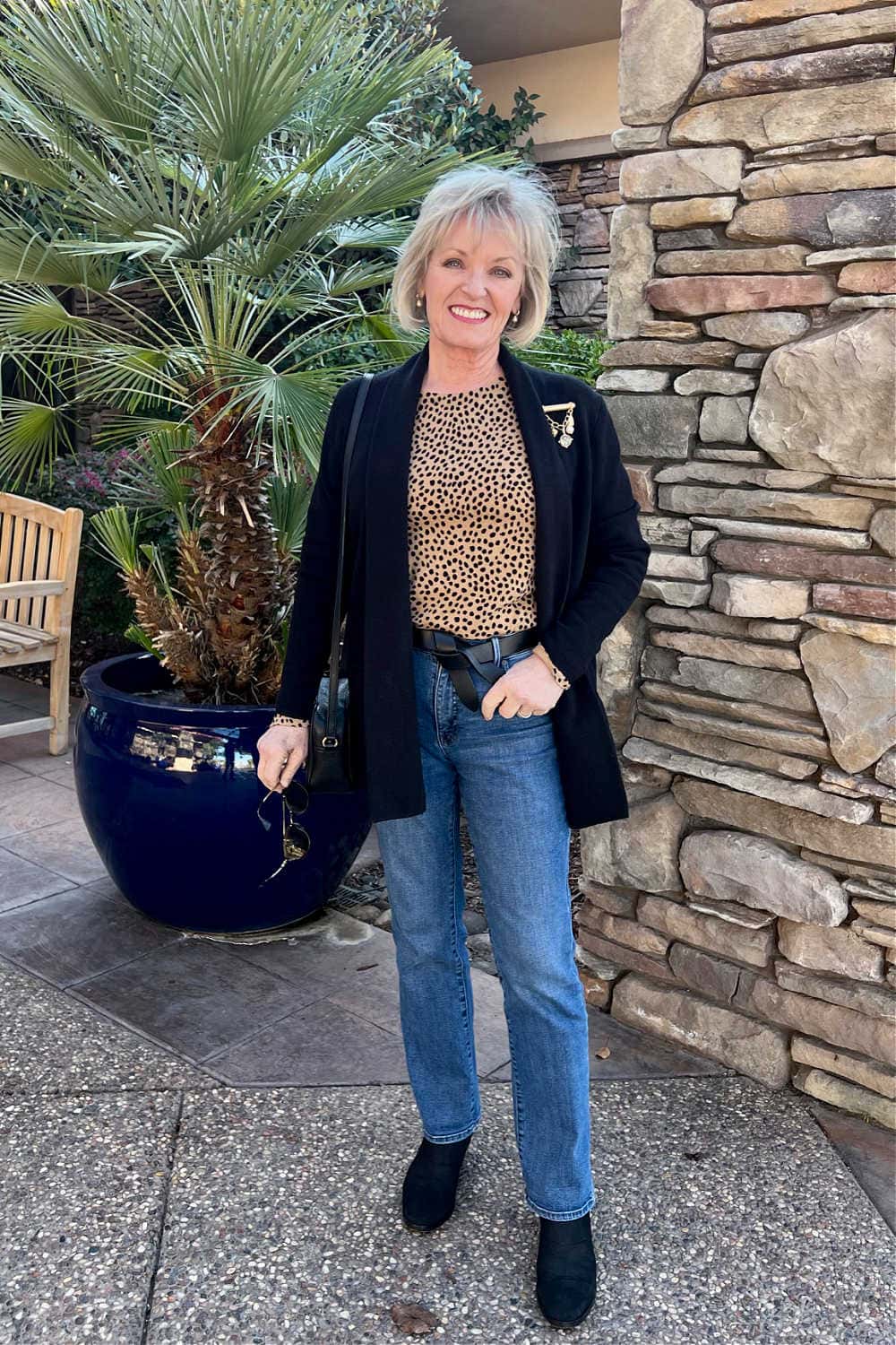 woman wearing sweater blazer with jeans to elevate casual outfit