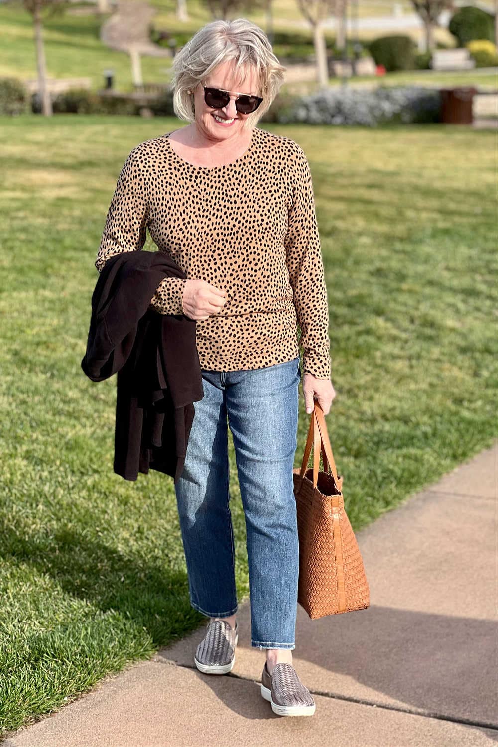 woman wearing leopard sweater and jeans